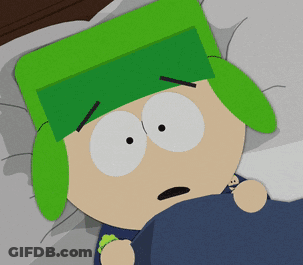 A Cartoon Character With Green Ears And A Green Hat Laying In Bed GIF
