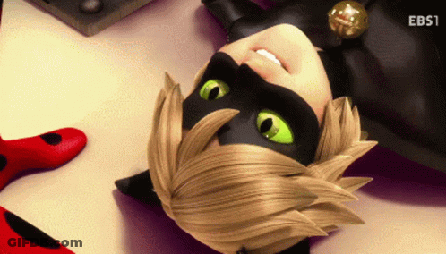 A Cartoon Character With Green Eyes Is Laying Down On The Floor GIF
