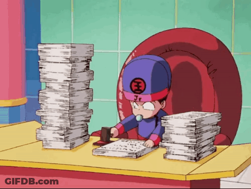 A Cartoon Character With Jr On His Hat Sits At A Desk With Stacks Of Papers GIF