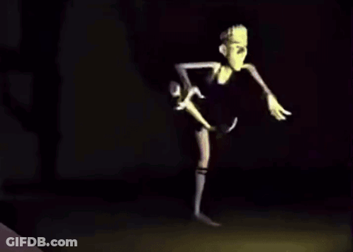 A Cartoon Character With Long Arms And Legs Is Dancing In The Dark . GIF