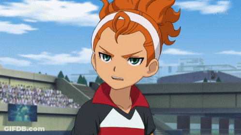 A Cartoon Character With Orange Hair And A White Headband Stands In Front Of A Crowd GIF
