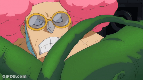 A Cartoon Character With Pink Hair And Glasses Is Surrounded By Green Leaves GIF