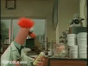 A Cartoon Character With Red Hair Is Holding A Bottle Of Hot Sauce GIF