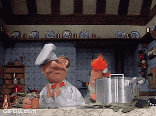 A Cartoon Chef Is Standing In A Kitchen With Plates On The Shelf GIF