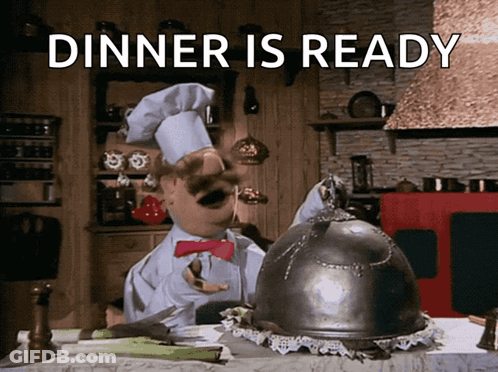 A Cartoon Chef Says Dinner Is Ready With A Cloche On The Table GIF