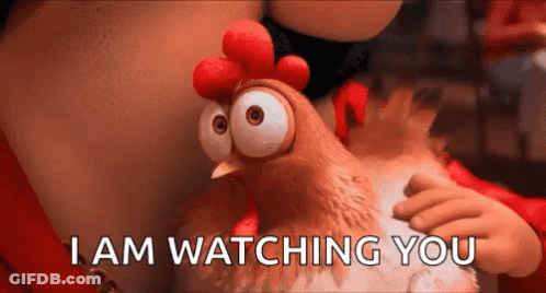 A Cartoon Chicken Says I Am Watching You While Being Held By A Person . GIF
