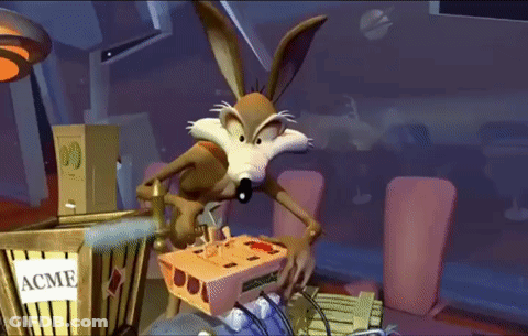 A Cartoon Coyote Is Playing A Video Game In Front Of A Box That Says Acme GIF