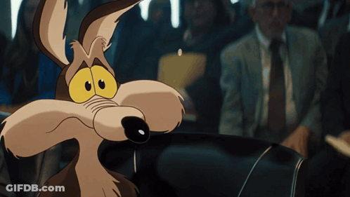 A Cartoon Coyote Is Sitting In A Car Looking At The Camera GIF