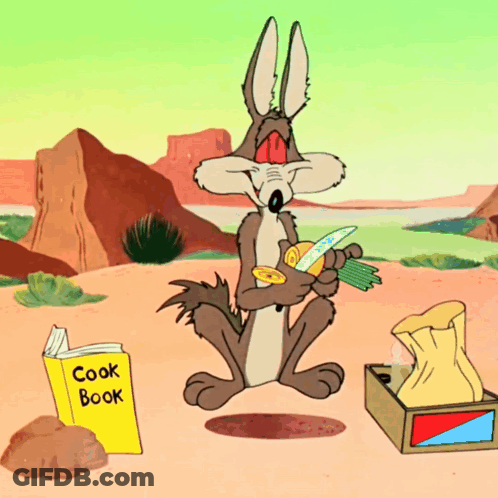 A Cartoon Coyote Sits Next To A Cook Book In The Desert GIF