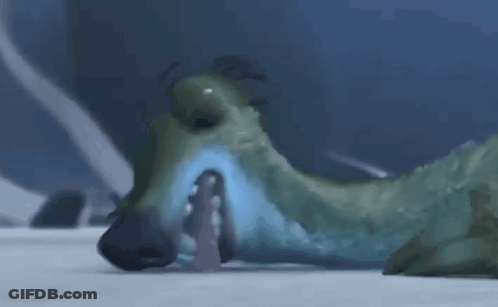A Cartoon Dinosaur Is Laying On The Ground With Its Mouth Open And A Person In The Background . GIF