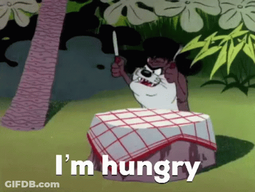 A Cartoon Dog Is Sitting At A Table Holding A Knife And Says I 'M Hungry GIF