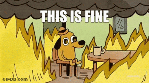 A Cartoon Dog Is Sitting At A Table With A Cup Of Coffee In Front Of A Fire With The Words This Is Fine . GIF