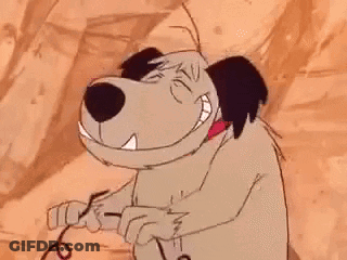 A Cartoon Dog Is Standing In Front Of A Rock Wall And Smiling At The Camera . GIF