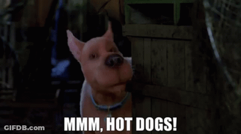 A Cartoon Dog Is Standing Next To A Wooden Crate And Says Mmmm Hot Dogs ! GIF