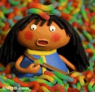 A Cartoon Doll Is Surrounded By A Pile Of Gummy Worms . GIF
