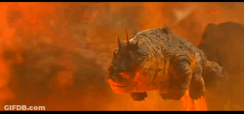 A Cartoon Dragon Is Flying Through The Air In Front Of A Mountain GIF