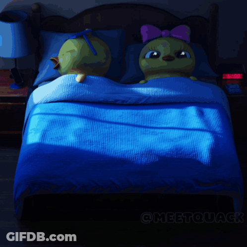 A Cartoon Drawing Of A Duck Laying On A Bed GIF