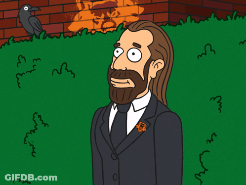 A Cartoon Drawing Of A Man With A Beard Wearing A Black Suit And Tie With An Orange Pin With The Letter R On It GIF