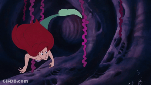 A Cartoon Drawing Of A Mermaid With Red Hair GIF