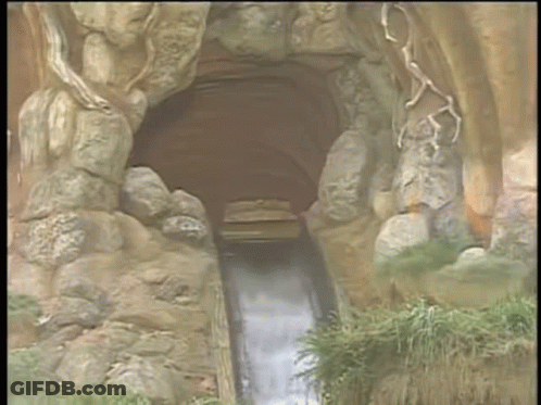 A Cartoon Drawing Of A Zip Ride Going Through A Cave GIF