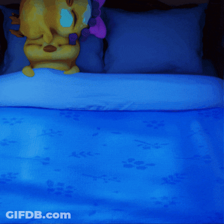 A Cartoon Duck Is Sleeping On A Bed With A Blue Blanket GIF