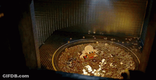 A Cartoon Duck Is Swimming In A Pool Of Gold Coins GIF