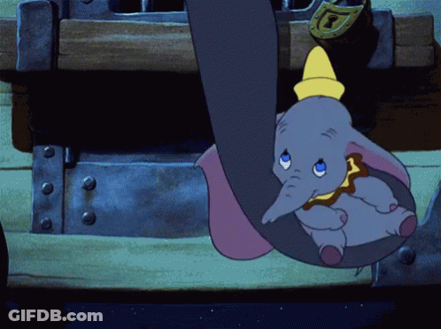 A Cartoon Elephant Hanging From A Trunk With A Yellow Hat On GIF