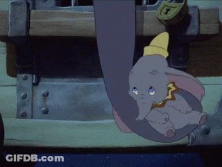A Cartoon Elephant Is Hanging From A Trunk With A Lock On It GIF