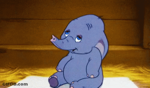 A Cartoon Elephant Is Sitting On A Rug And Looking At Something GIF
