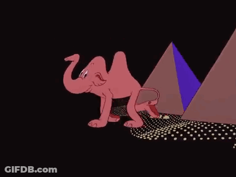 A Cartoon Elephant Is Walking In Front Of A Pyramid In The Dark . GIF