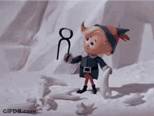 A Cartoon Elf Is Holding A Pair Of Scissors In His Hand . GIF