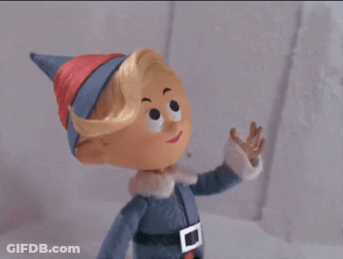 A Cartoon Elf Is Waving His Hand In The Air . GIF
