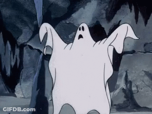 A Cartoon Ghost With A Surprised Look On His Face Is Standing In Front Of A Rock Wall . GIF