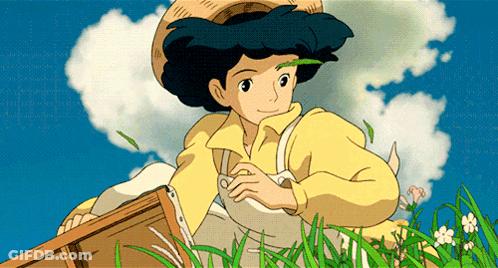 Girl In Yellow Shirt And Straw Hat Sitting In Grass GIF