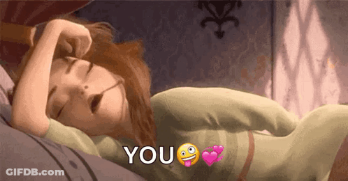 A Cartoon Girl Is Sleeping On A Bed With The Words `` You '' Written On It . GIF