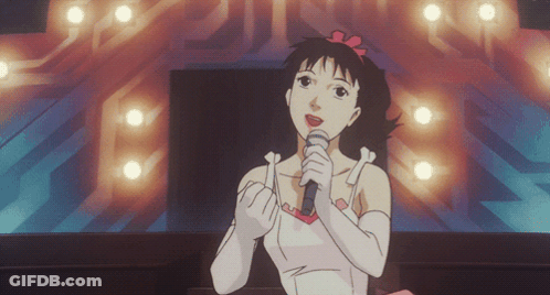 A Cartoon Girl Singing Into A Microphone In Front Of A Stage GIF
