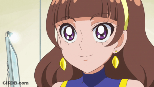 A Cartoon Girl With Brown Hair And Yellow Earrings Is Smiling GIF