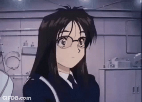 A Cartoon Girl With Long Hair And Glasses Is Standing In A Room . GIF