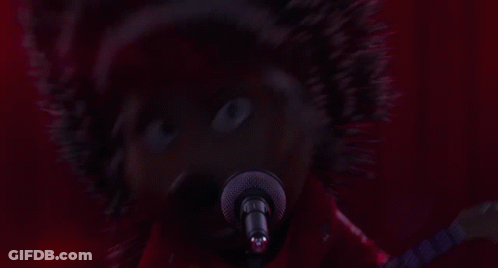 A Cartoon Hedgehog Is Singing Into A Microphone And Playing A Guitar GIF