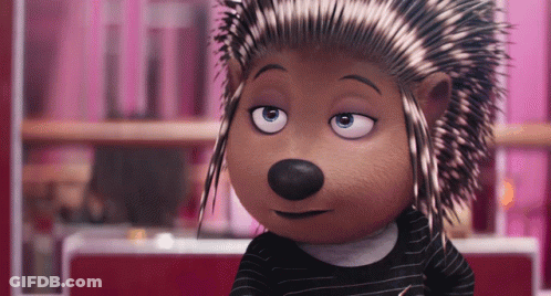 A Cartoon Hedgehog Wearing A Black And White Striped Shirt Is Looking At The Camera GIF