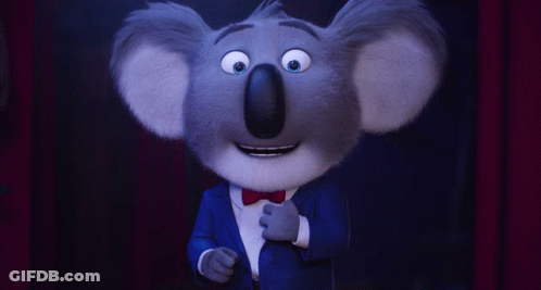 A Cartoon Koala Wearing A Blue Suit And A Bow Tie GIF