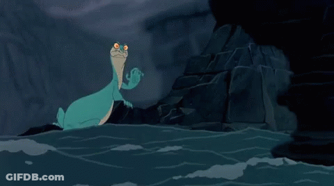 A Cartoon Lizard Is Sitting In The Water Near A Rock . GIF