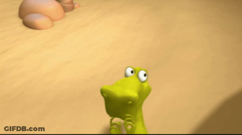 A Cartoon Lizard With A Big Mouth Is Standing On A Sandy Surface GIF