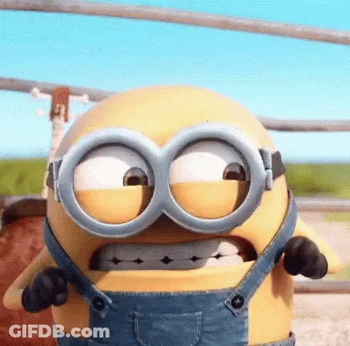 A Cartoon Minion Is Wearing Overalls And Goggles And Making A Funny Face . GIF