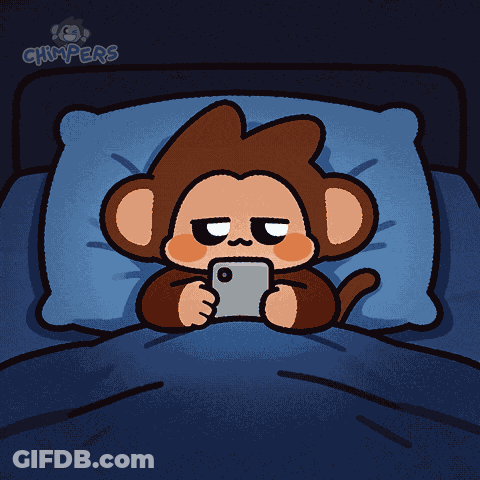 A Cartoon Monkey Is Laying In A Bed Looking At A Cell Phone GIF