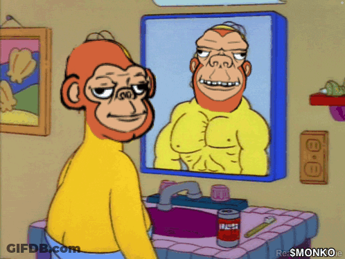 A Cartoon Monkey Looking At His Reflection In A Mirror GIF