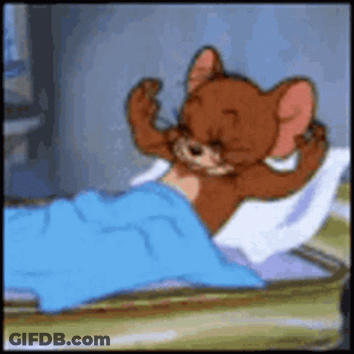 A Cartoon Mouse Is Laying In A Bed With A Blue Blanket GIF