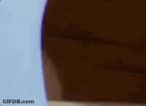 A Cartoon Mouse Is Peeking Out From Behind A Wall And Covering His Face . GIF