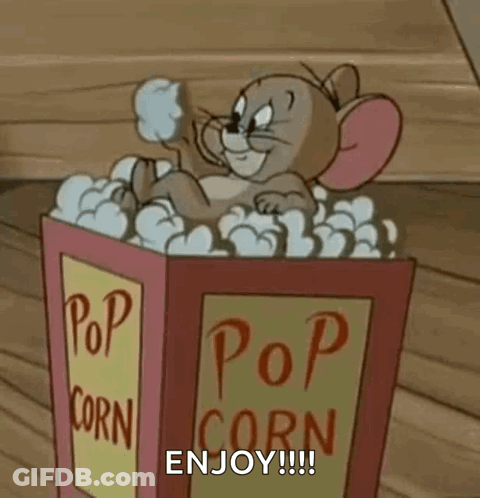 A Cartoon Mouse Is Sitting In A Bucket Of Popcorn And Says `` Enjoy '' . GIF