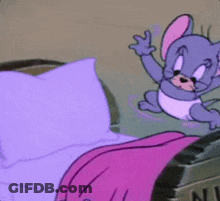 A Cartoon Mouse Is Sitting On A Bed With Purple Sheets GIF